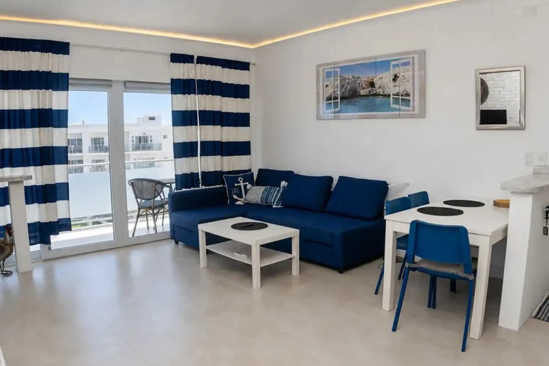 1-Bedroom Furnished Apartment with Ocean View Balcony in Sosúa — Open living & dining area