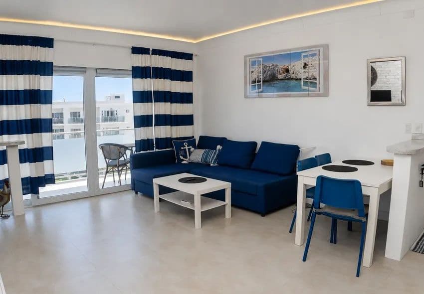 1-Bedroom Furnished Apartment with Ocean View Balcony in Sosúa — Open living & dining area