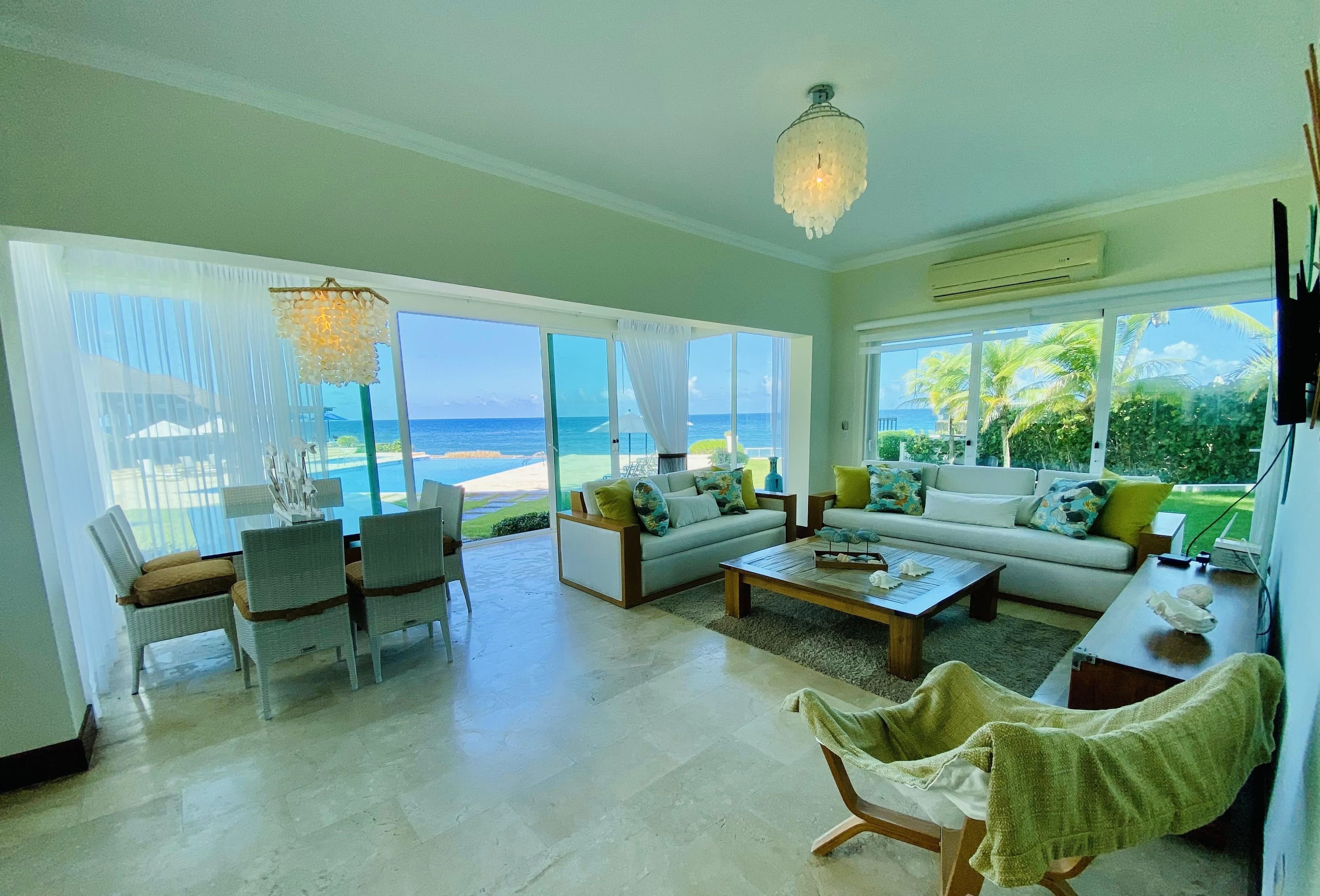 3-Bedroom Beachfront Apartment with Ocean Views in Laguna Beach, Sosúa — Open living & dining area
