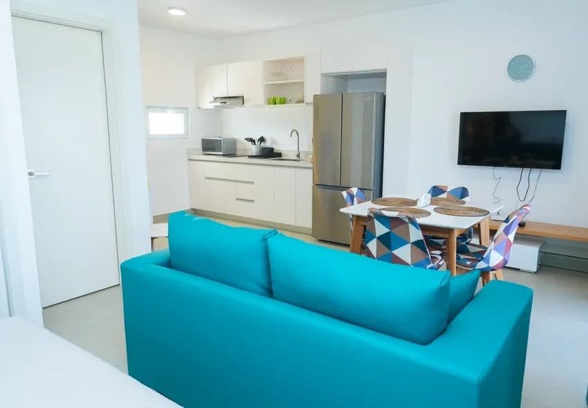 1-Bedroom Furnished Apartment with Shared Pool in Laguna City, Sosúa — Open living & dining area