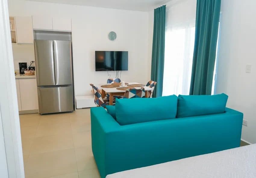 1-Bedroom Furnished Apartment with Shared Pool in Laguna City, Sosúa — Open living & dining area