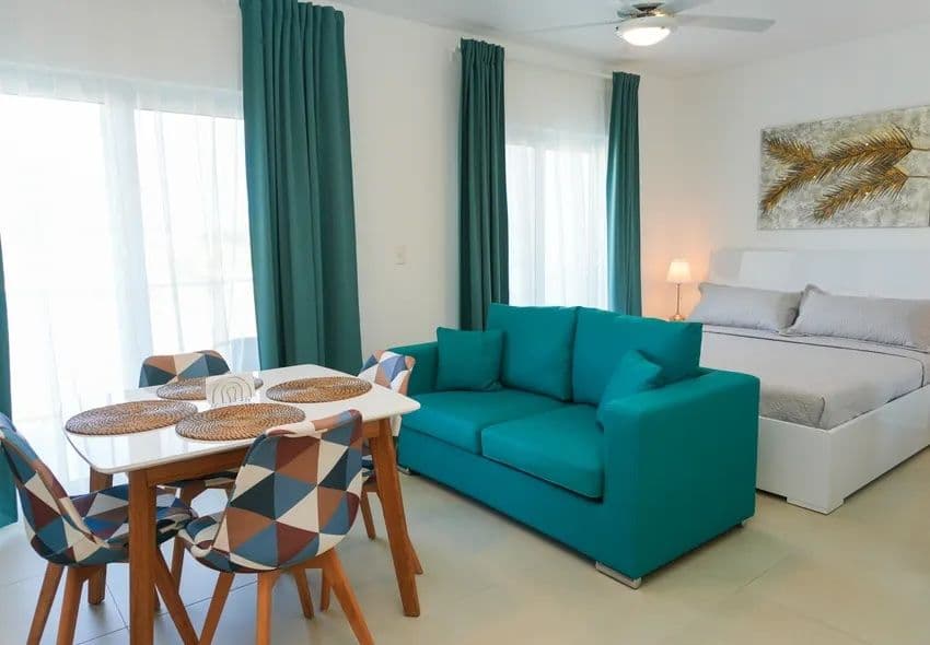1-Bedroom Furnished Apartment with Shared Pool in Laguna City, Sosúa — Open living & dining area